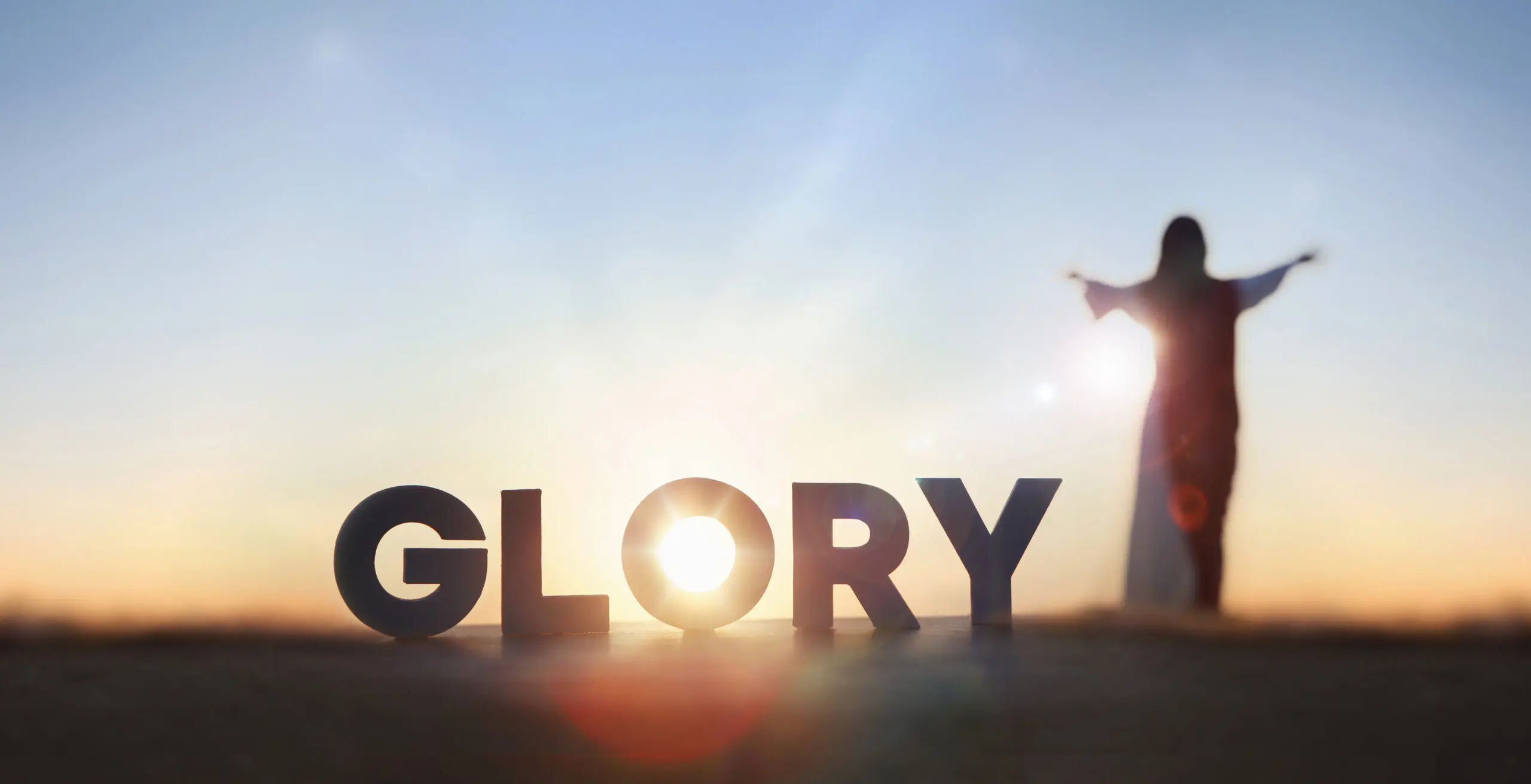 Silhouette and 'Glory' text at sunset.
