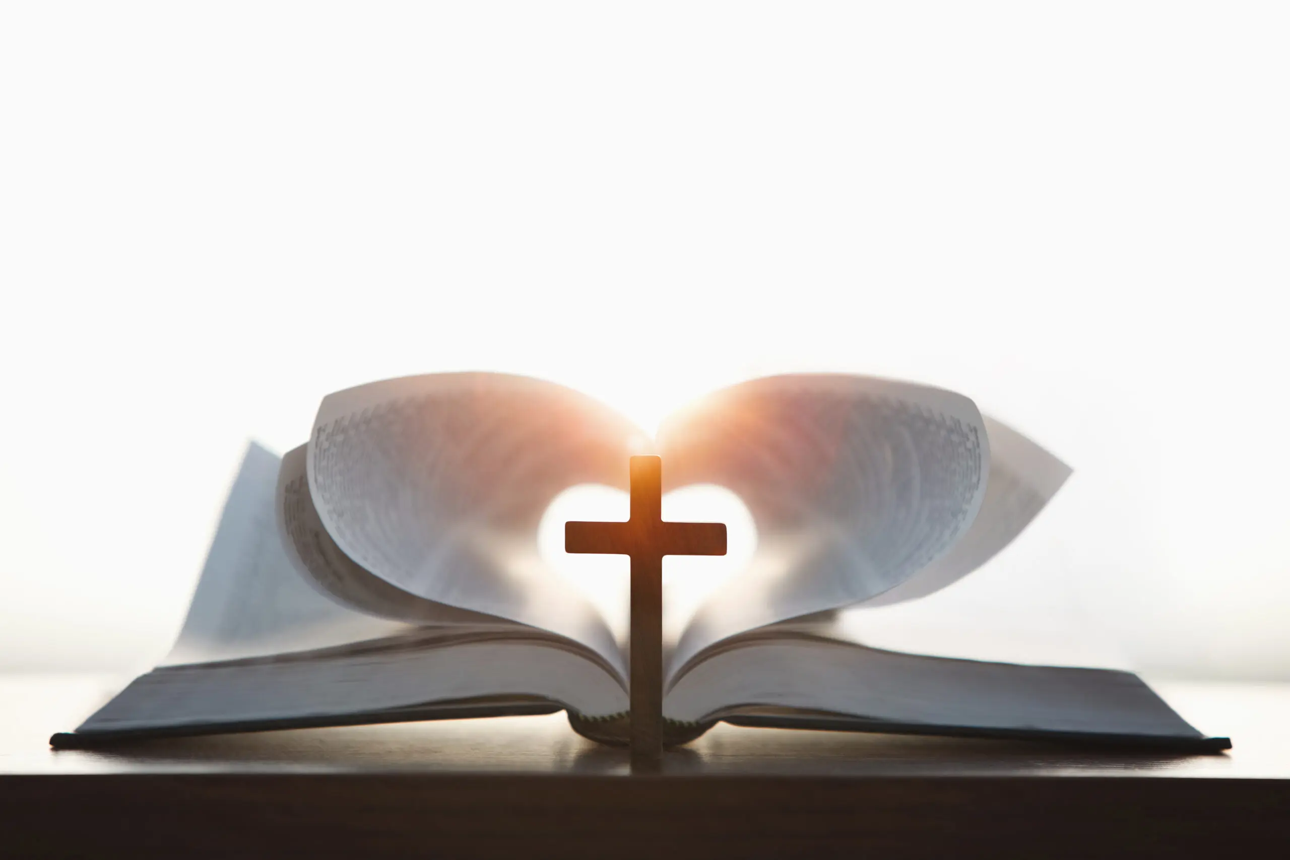 Open Bible with a cross and light.