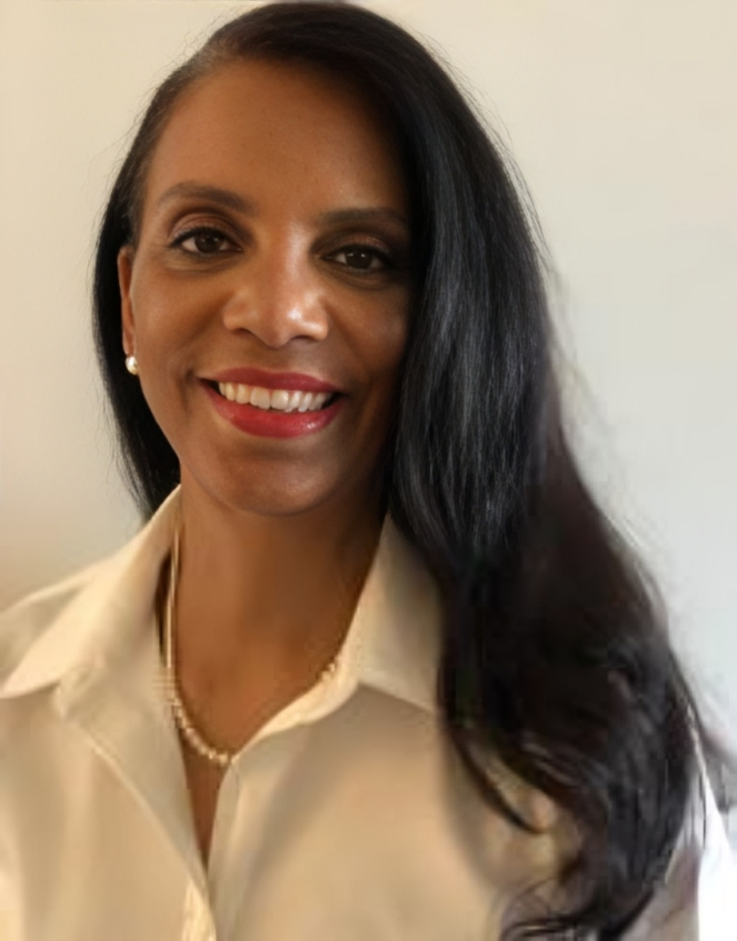 Smiling woman with long hair in blouse.