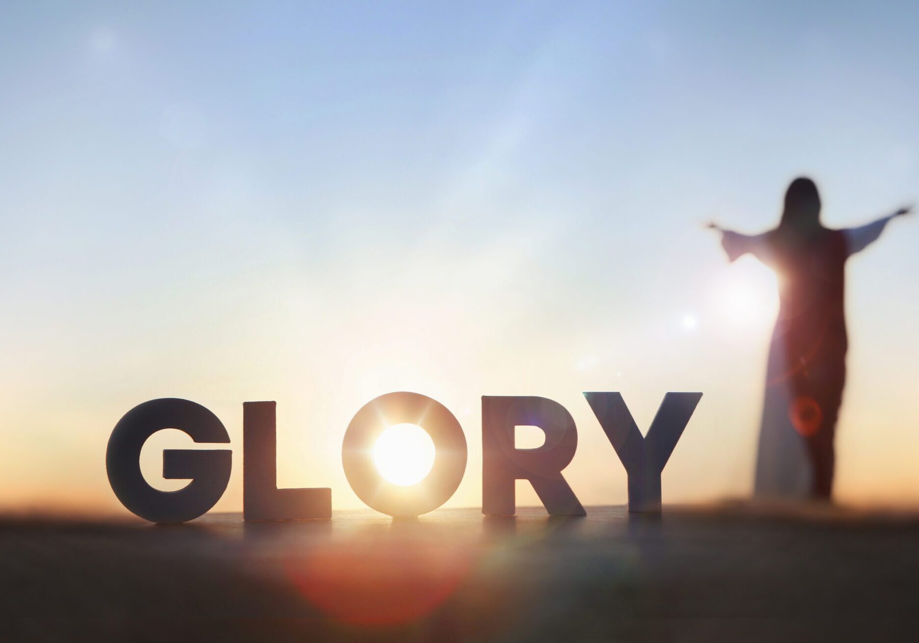 Silhouette and 'Glory' text at sunset.