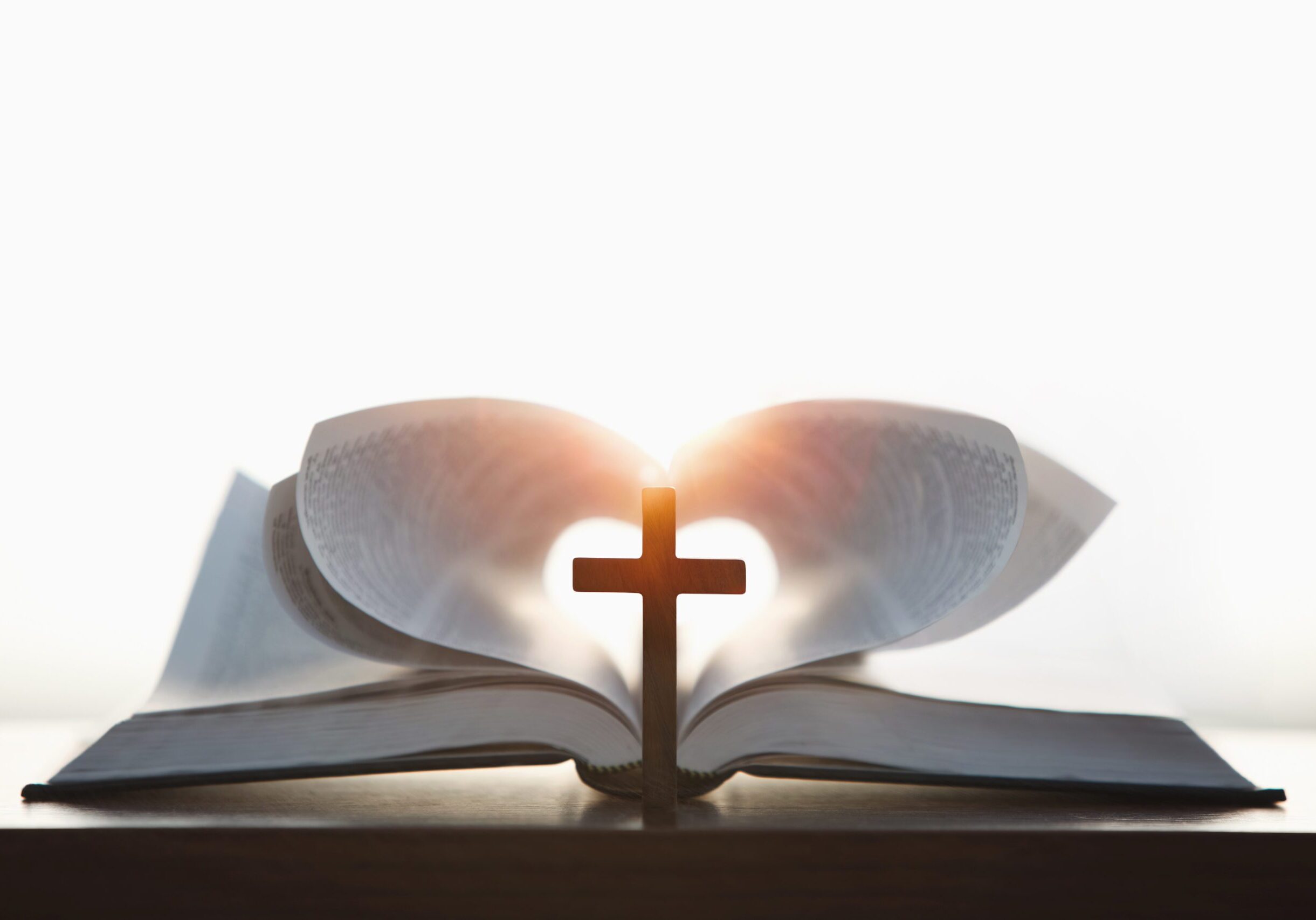 Open Bible with a cross and light.